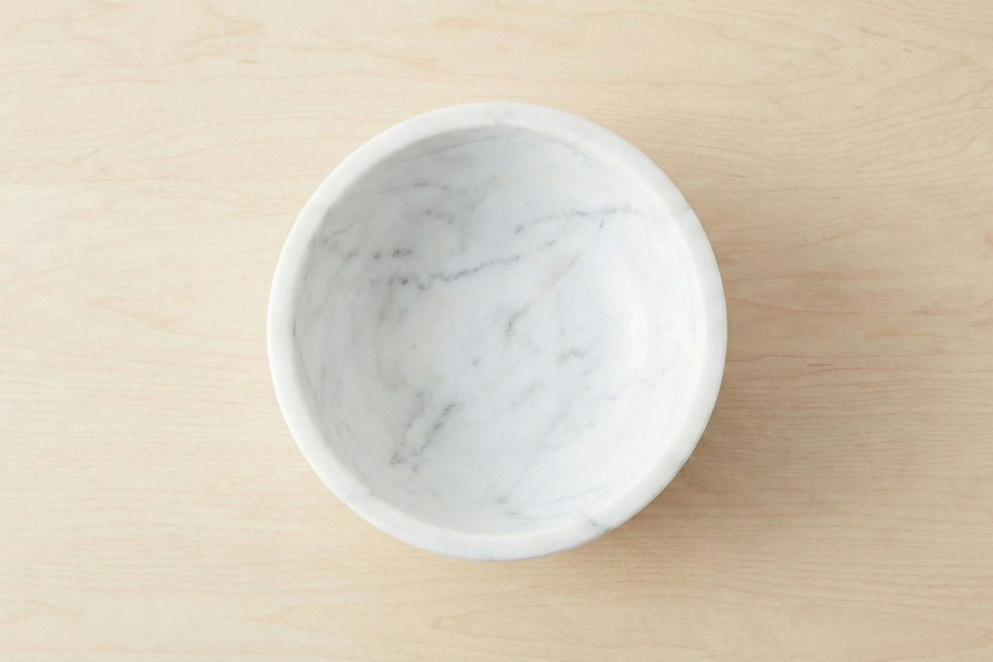 White marble bowl on a beige surface